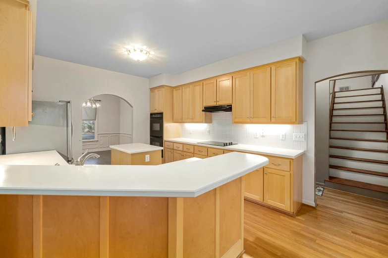 large modern kitchen with hardwood and stainless steel appliances