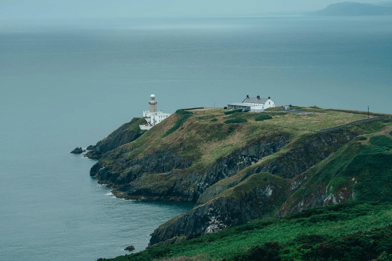 a lighthouse near the sea on top of an island