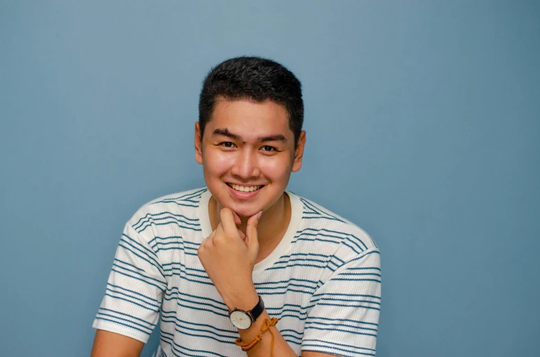 a man smiling while looking at the camera