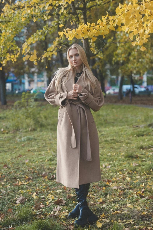 a woman is standing on the grass with her arms crossed