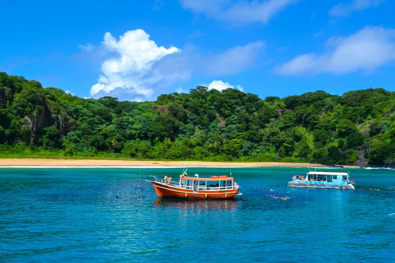 two boats sitting on top of a blue body of water