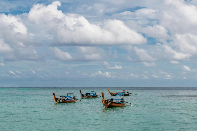 some boats floating on top of the ocean