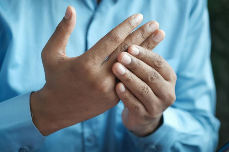 a man holding hands to symbolize the cross