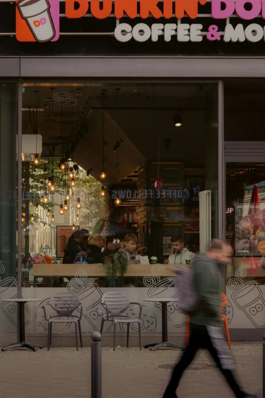 a man is walking past a coffee shop