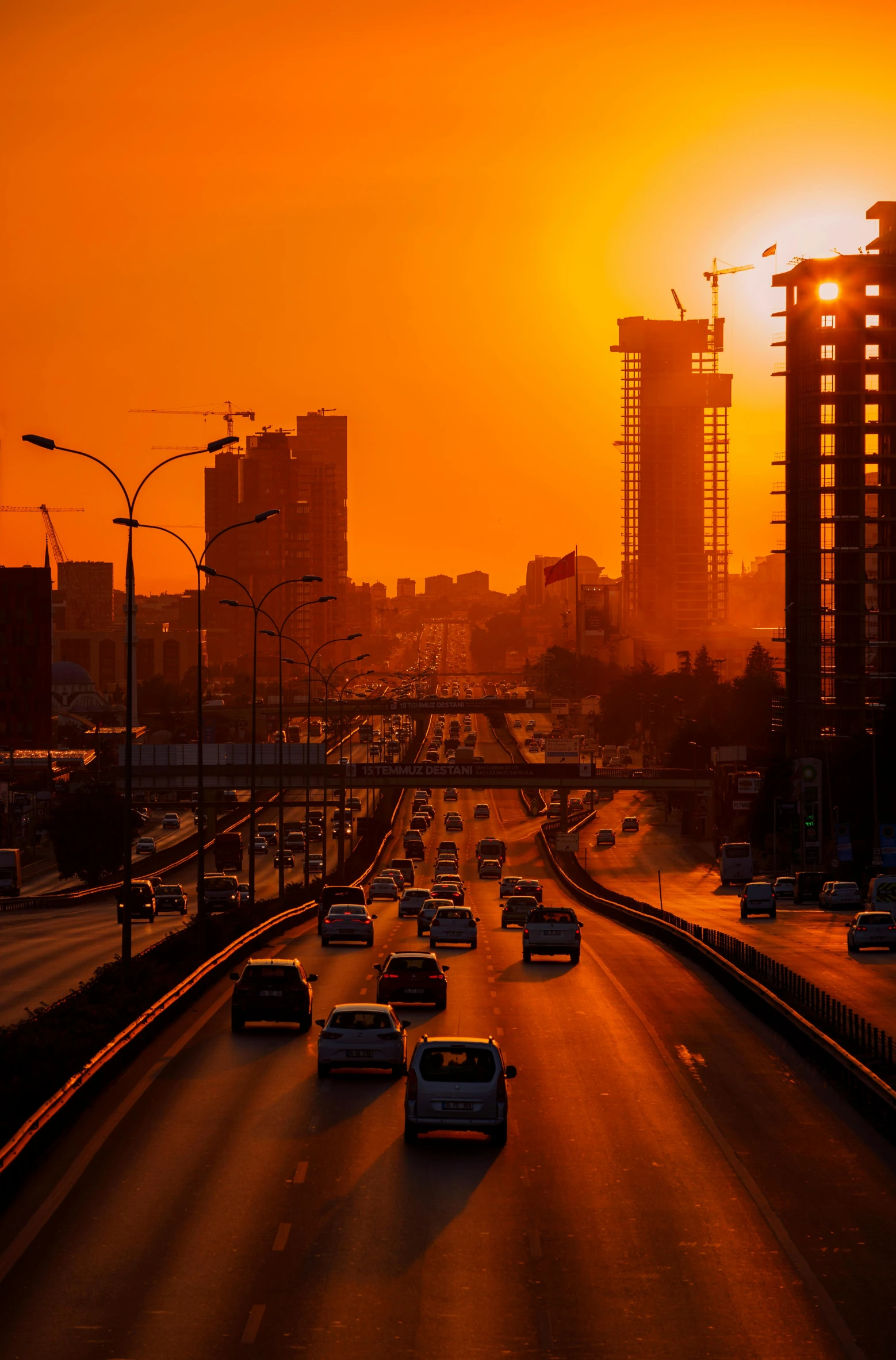 several cars traveling on the highway at sunset