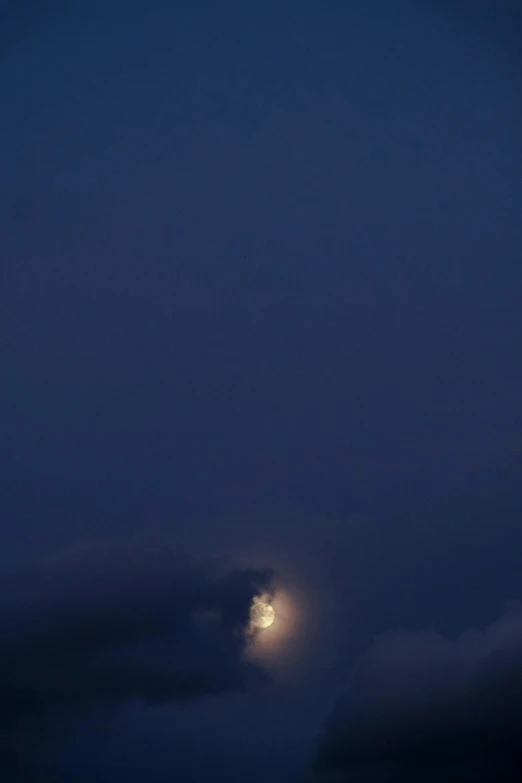 the moon shines brightly as seen from an airplane