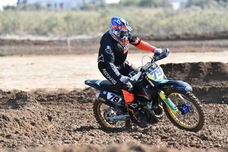 a dirt bike rider is riding his bike on the track