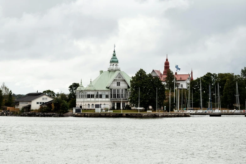 a boat travels past large buildings near a dock