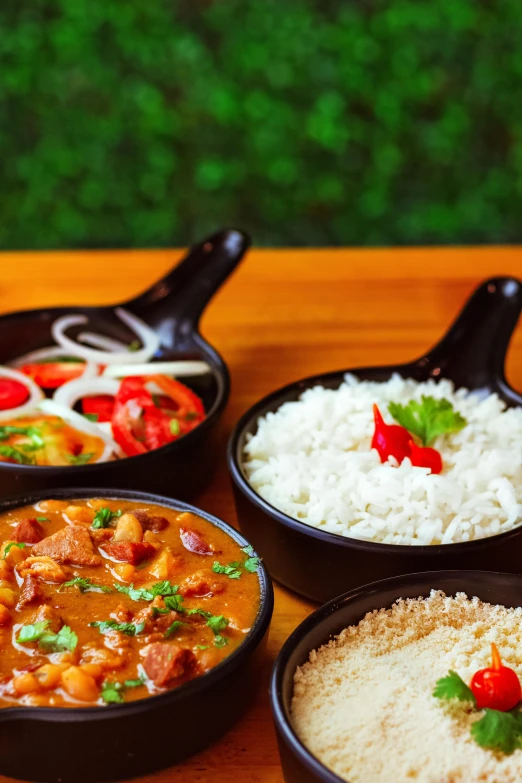 several bowls are filled with rice, meat and other things