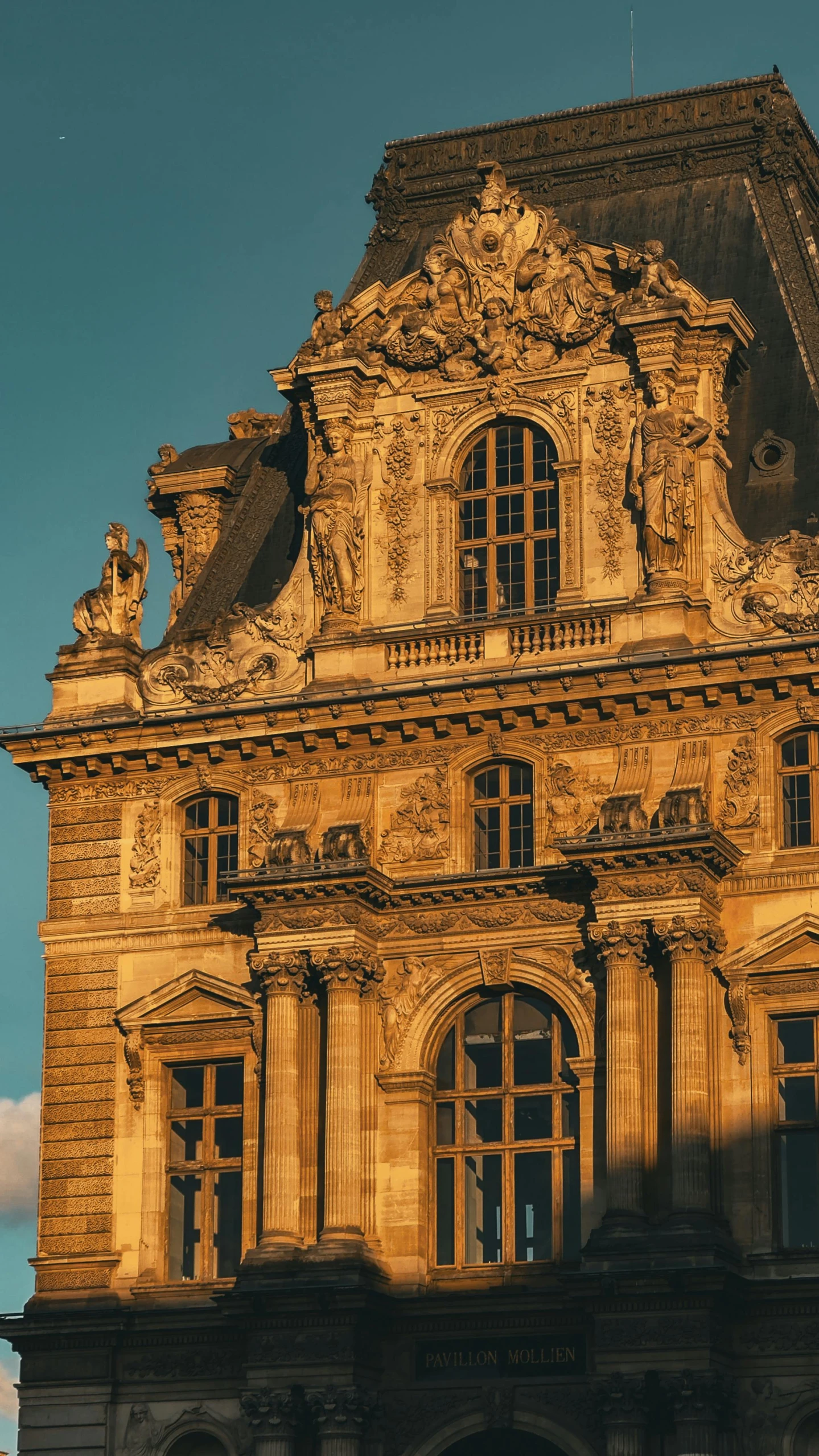 a golden color building stands against the blue sky