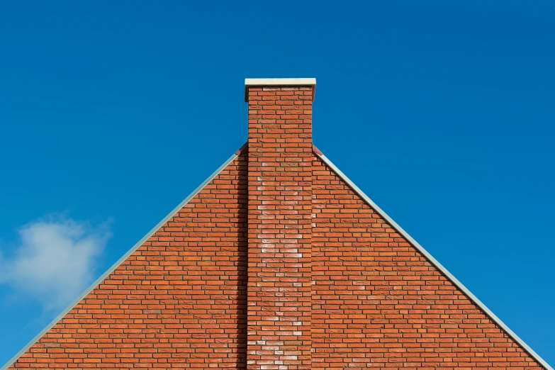 red brick building under blue sky with green grass