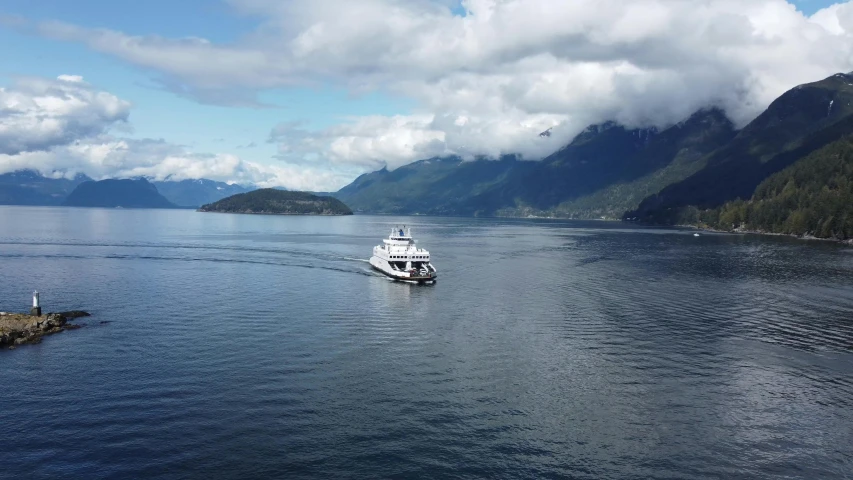 a large white boat floating in the middle of a lake