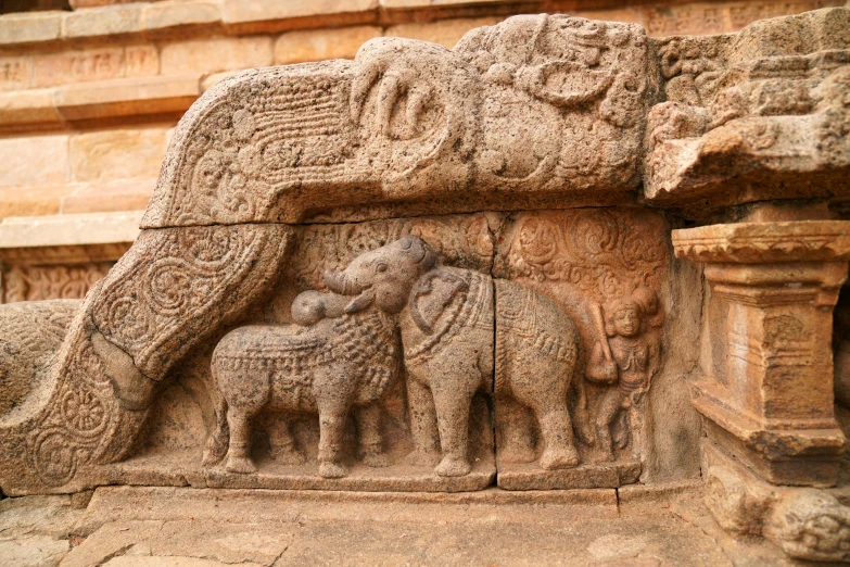 a carving depicting elephants and other creatures in an ancient style