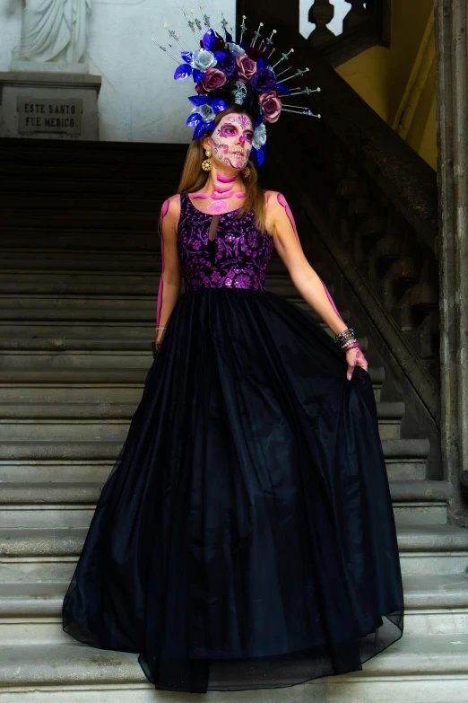 a young woman in a black and purple dress and headpiece