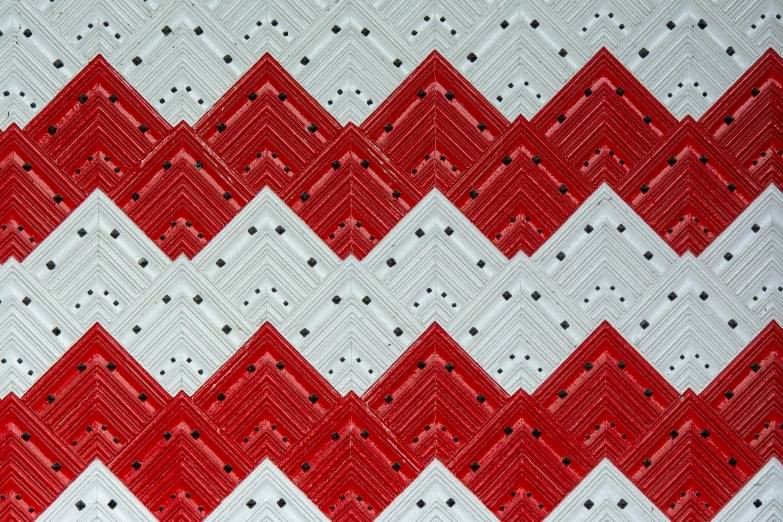 a closeup s of an unusual red and white quilt