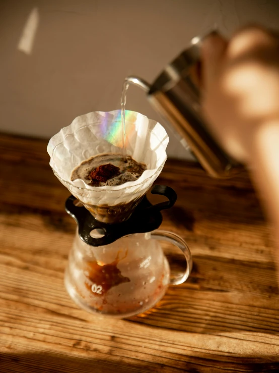 coffee being made from a paper cup on the table