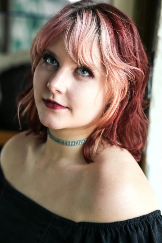 a young woman with pink hair is wearing a choker