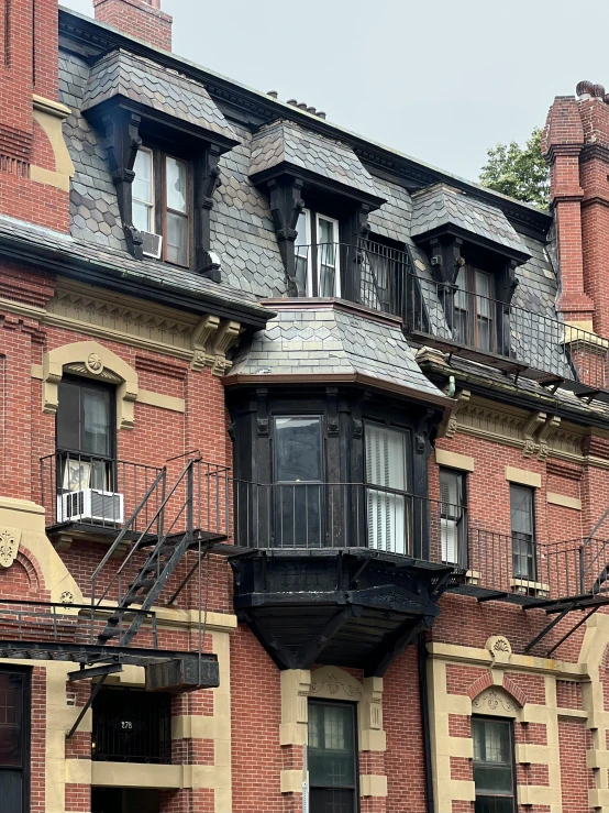 an old building with a red door and many windows