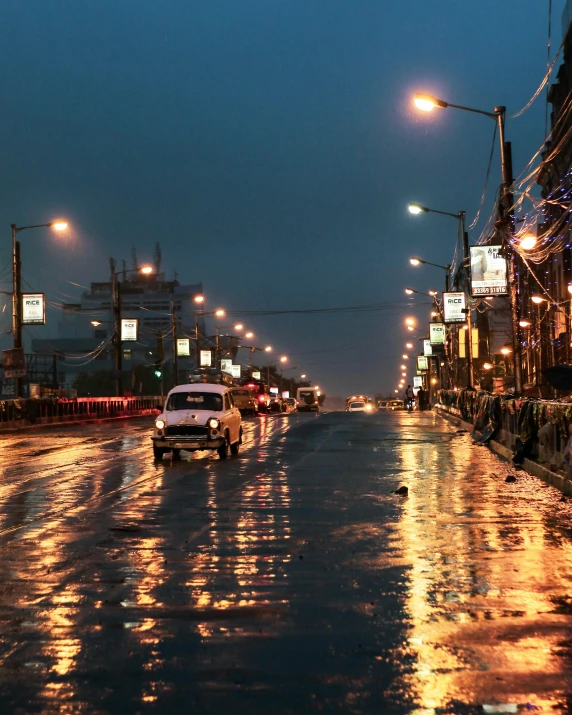 car and truck driving down the road in the rain