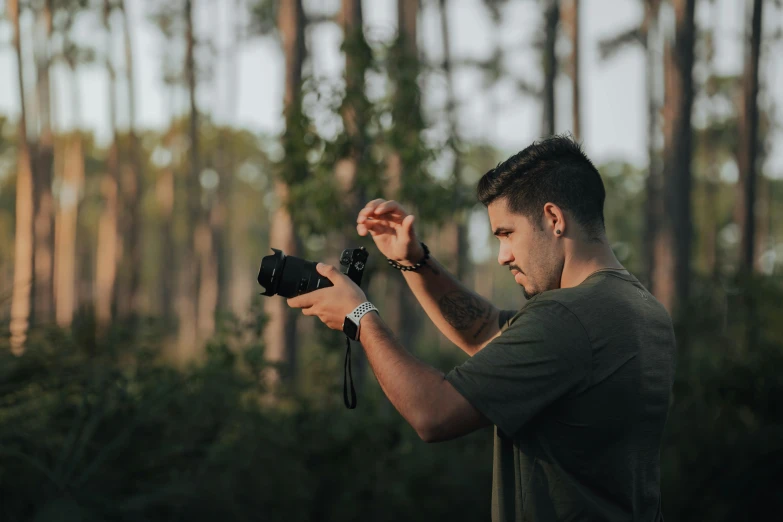 a man holding a digital camera in his hand