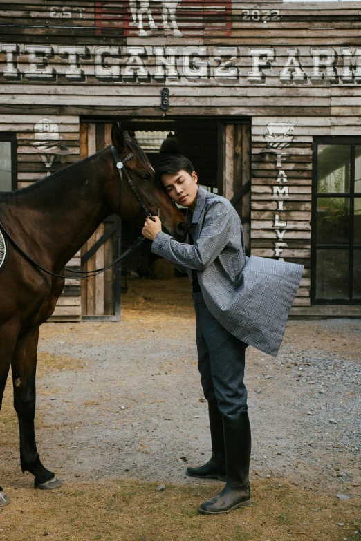 a man holding the reins of a horse