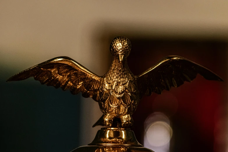 a gold eagle trophy is in the middle of a table