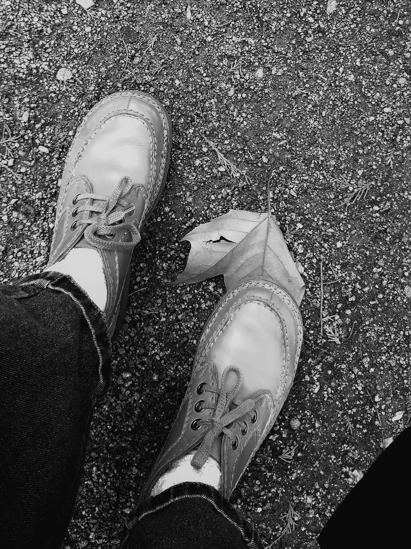 someone standing outside in black and white sneakers