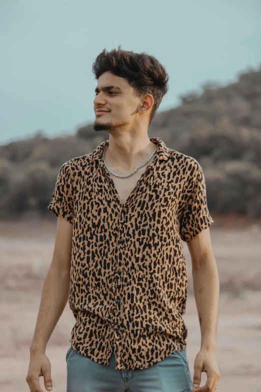 man with necklace in animal print shirt looking at soing