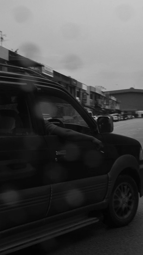 some cars parked along the street on a cloudy day