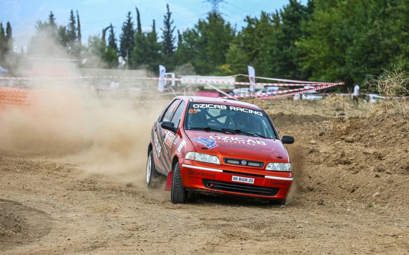 a rally car driving around a dirt track