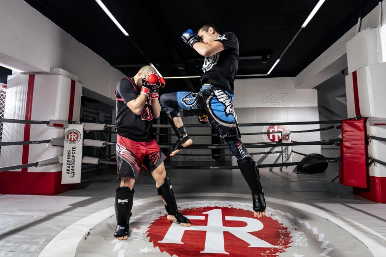 two people in a ring with pads and gloves on