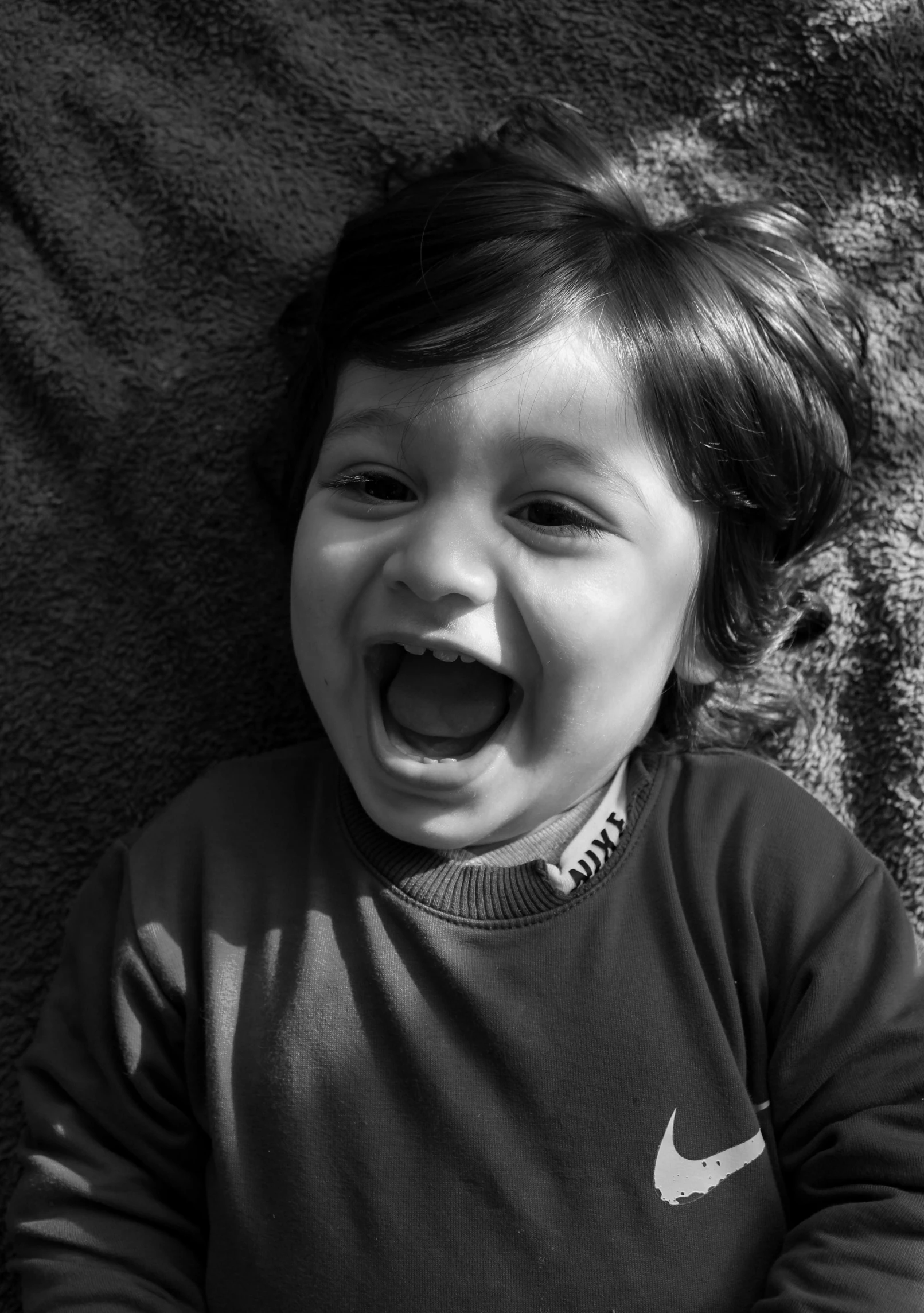 a little boy making a funny face with his mouth wide open