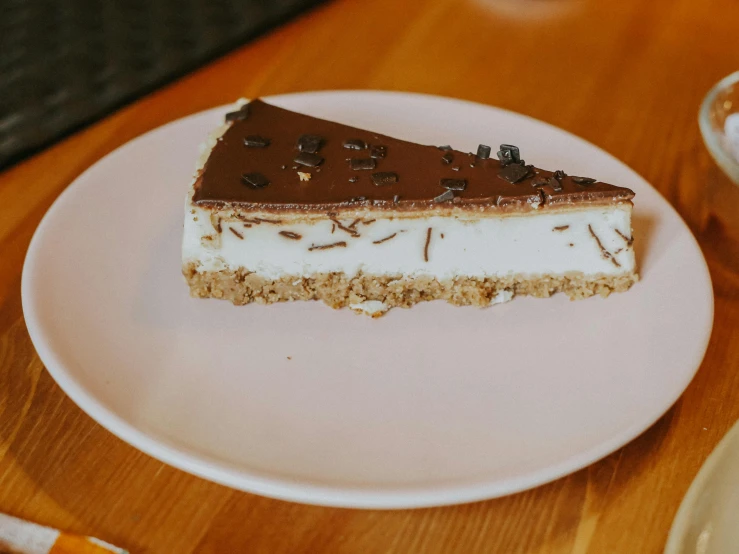 a slice of cake with cream and chocolate topping