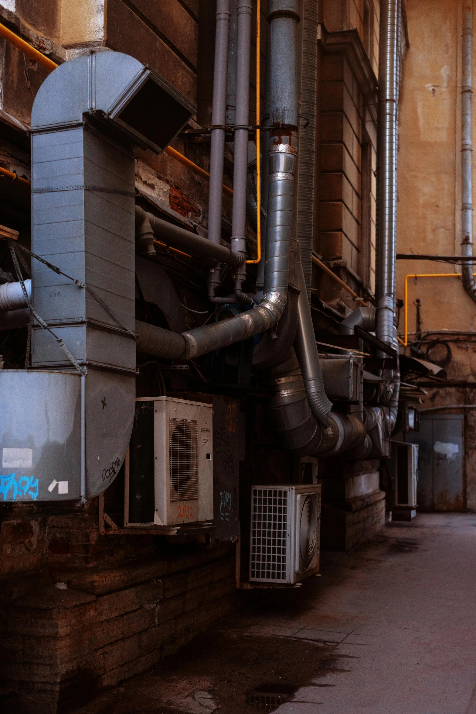 a closeup view of pipes, machinery and some trash