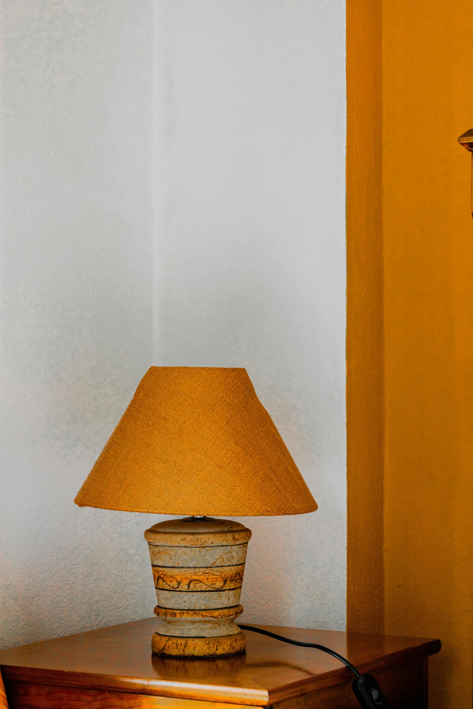 a lamp is next to an open book on a desk