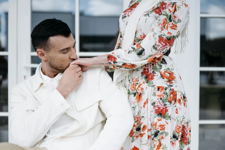 a man with a suit on sitting next to a woman