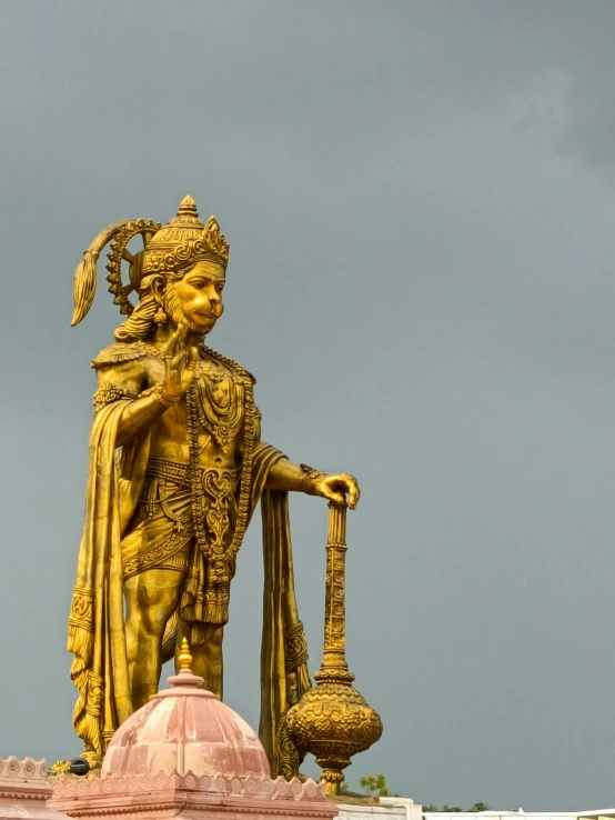 the statue of the hindu person, who is holding a hook in one hand and another has an egg