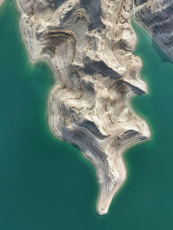 an aerial view of a placid body of water