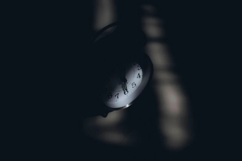 a clock with words written on it in the dark