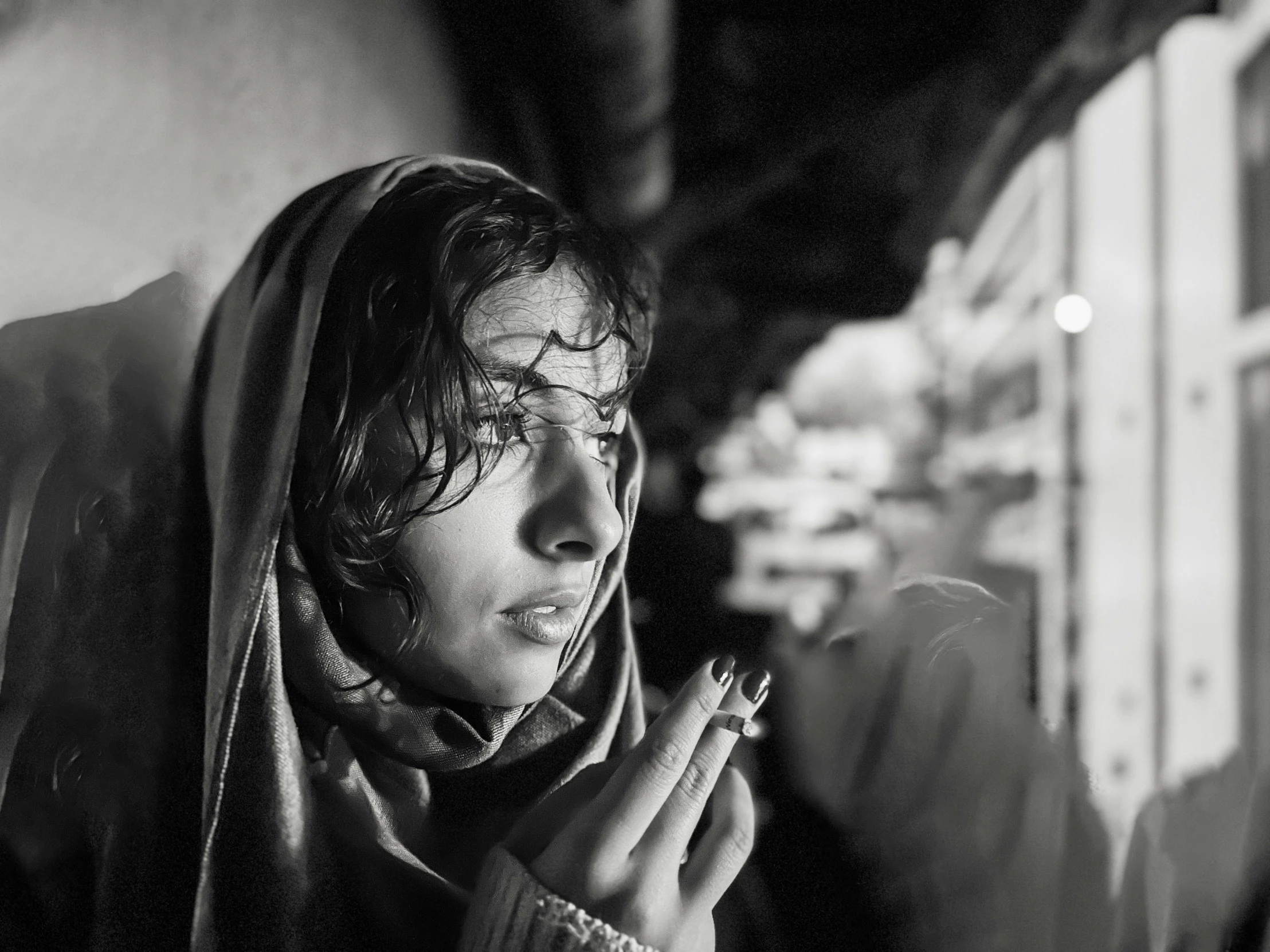 black and white image of a woman smoking a cigarette