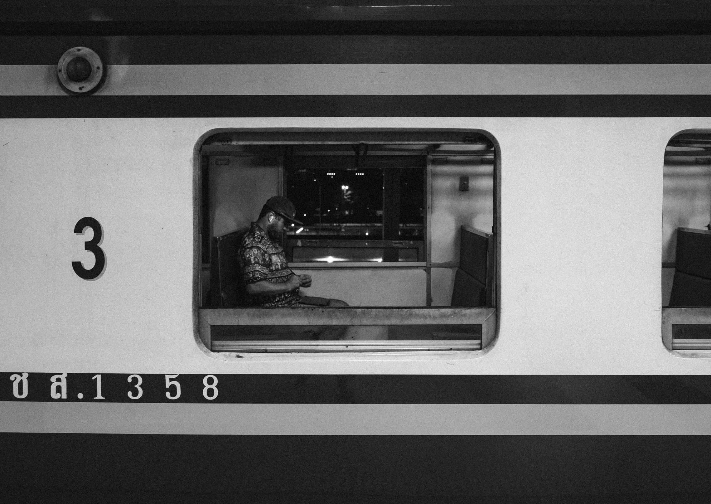 the side of a train with some people standing on it