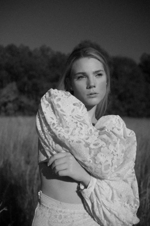 a woman standing in the middle of a field