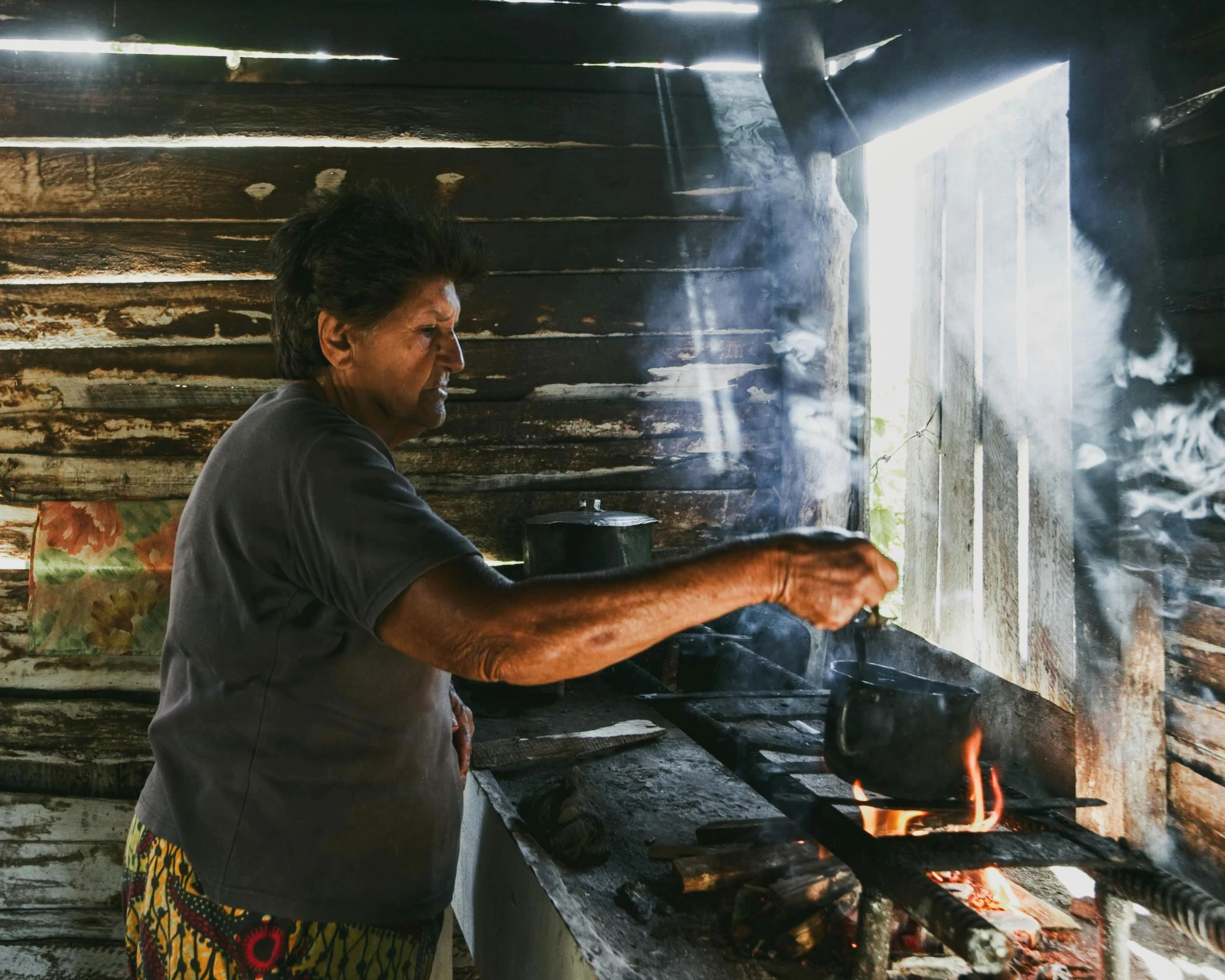 a man cooking on top of an outdoor grill