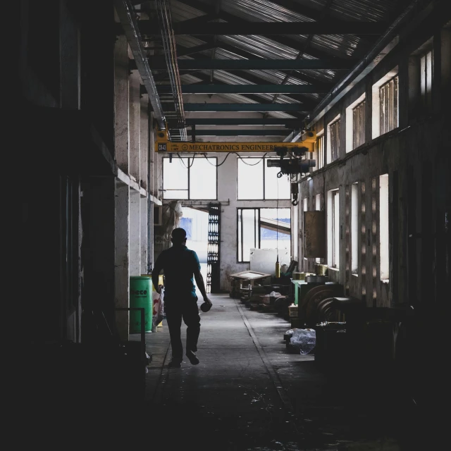 a person walking inside of a building under construction