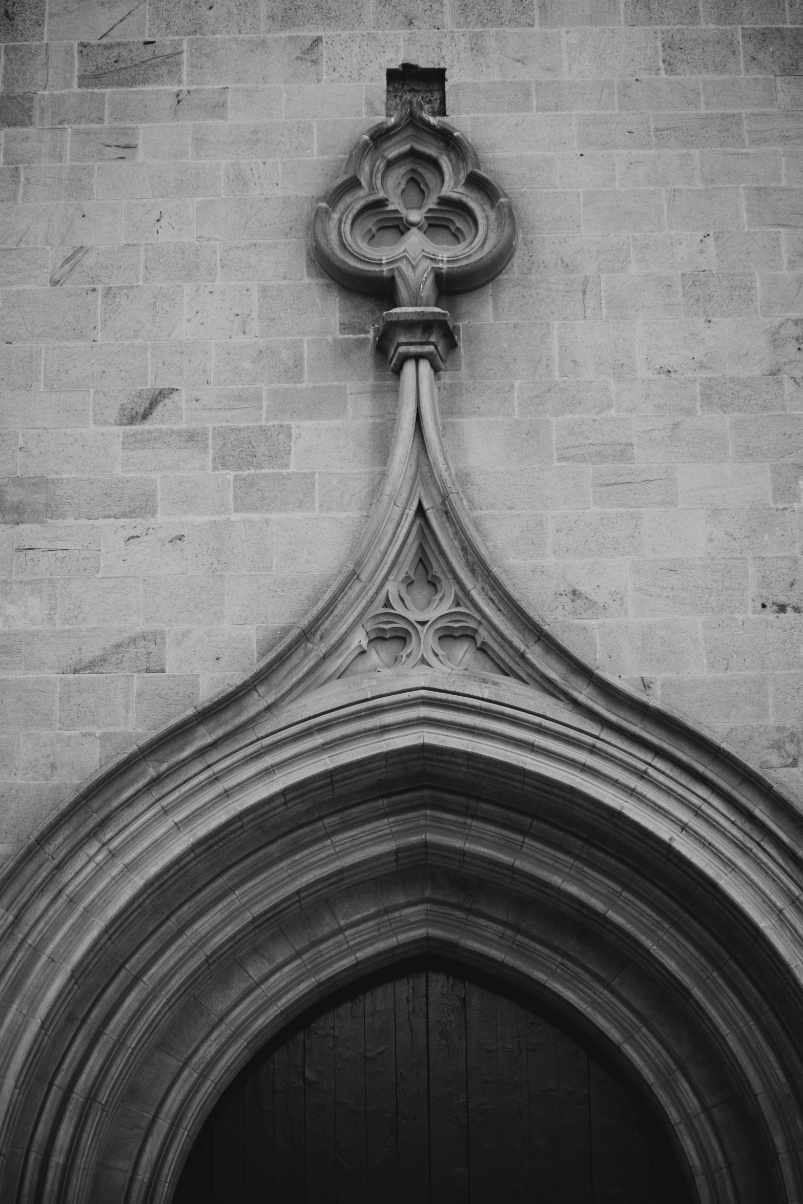 a doorway with an archway and a door handle