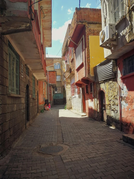 a cobblestone street with windows and colorful buildings