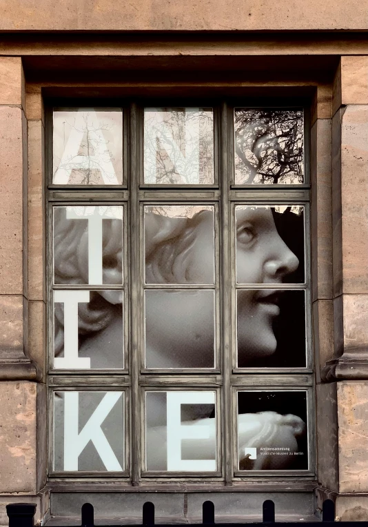 a very old looking building has a large window that is written like ike