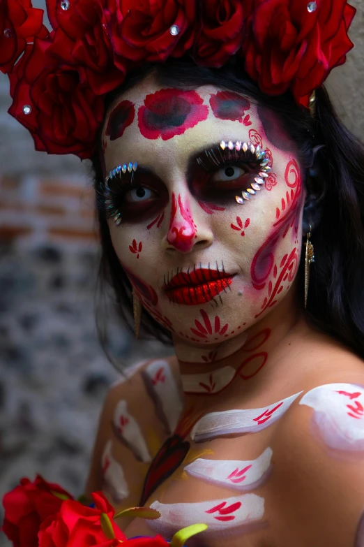 a woman is dressed up and wearing red and white face paint