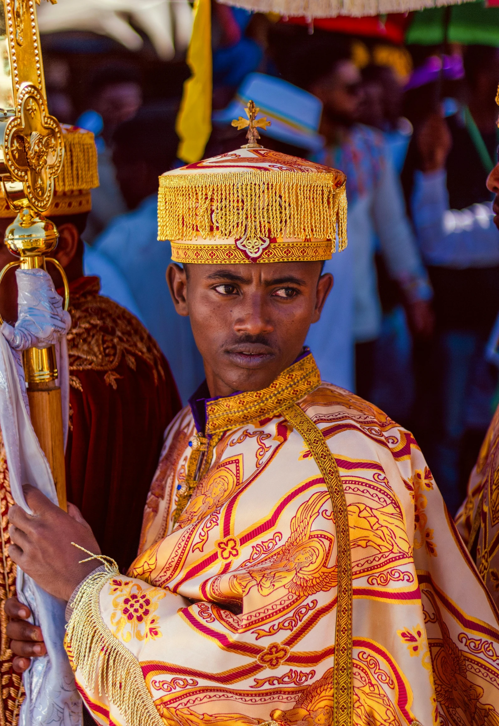 a man with traditional garb standing next to other people