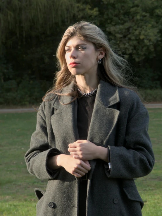 a woman with long hair is posing for a picture